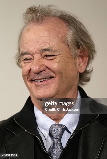 Actor Bill Murray poses in front of the painting 'Cupid Complaining to Venus' by Lucas Cranach the Elder as he attends a photocall for "The Monuments...