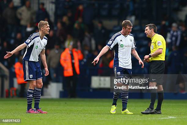 Darren Fletcher and Chris Brunt of West Brom appeal to Referee Lee Probert during the Barclays Premier league match West Bromwich Albion and Queens...