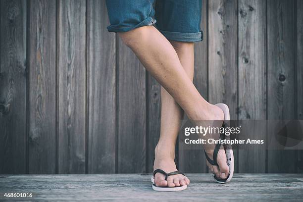 man's summer legs with flip flops - thong stock pictures, royalty-free photos & images