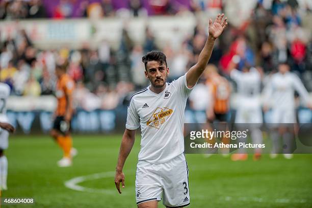 Neil Taylor of Swansea City applauds fans as he leaves the field after the final whistle during the Barclays Premier League match between Swansea...