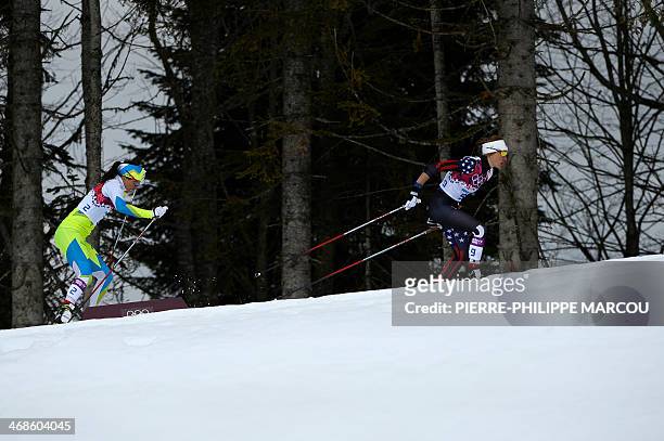 Sophie Caldwell and Slovenia's Katja Visnar compete in the Women's Cross-Country Skiing Individual Sprint Free Quarterfinals at the Laura...
