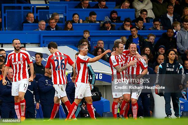Charlie Adam of Stoke City celebrates with team-mates after scoring his team's first goal during the Barclays Premier League match between Chelsea...