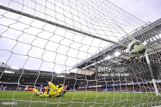 The ball slams into the back of the net as Chelsea's Belgian goalkeeper Thibaut Courtois falls into his own goal after chasing back but failing to...