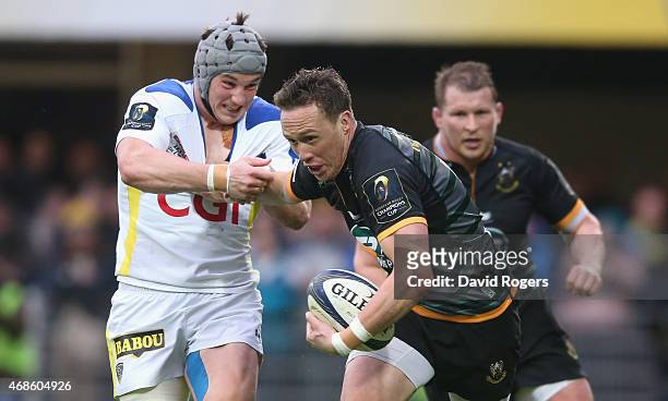 James Wilson of Northampton holds off Jonathan Davies during the European Rugby Champions Cup quarter final match between Clermont Auvergne and...