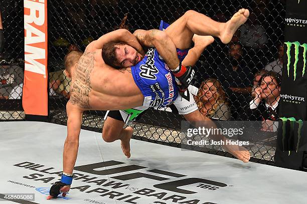 Clay Guida takes down Robbie Peralta in their featherweight fight during the UFC Fight Night event at the Patriot Center on April 4, 2015 in Fairfax,...