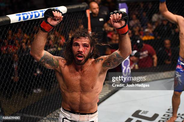 Clay Guida celebrates after defeating Robbie Peralta in their featherweight fight during the UFC Fight Night event at the Patriot Center on April 4,...