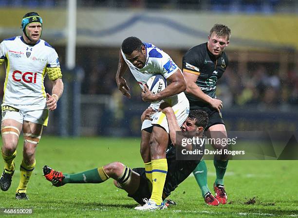 Naipolioni Nalaga of Clermont Auvergne is held by Calum Clark during the European Rugby Champions Cup quarter final match between Clermont Auvergne...