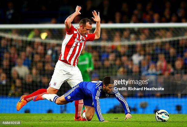 Eden Hazard of Chelsea battles for the ball with Charlie Adam of Stoke City during the Barclays Premier League match between Chelsea and Stoke City...