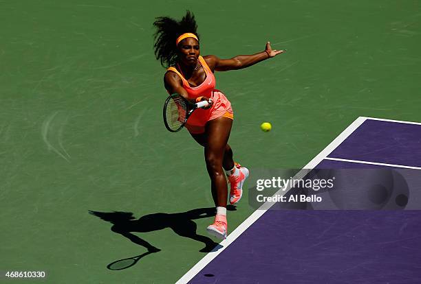 Serena Williams returns the ball against Carla Suarez Navarro of Spain during the Women's Finals match on day 13 of the Miami Open at Crandon Park...