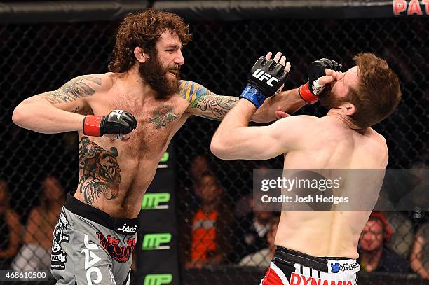 Michael Chiesa punches Mitch Clarke in the face in their lightweight fight during the UFC Fight Night event at the Patriot Center on April 4, 2015 in...