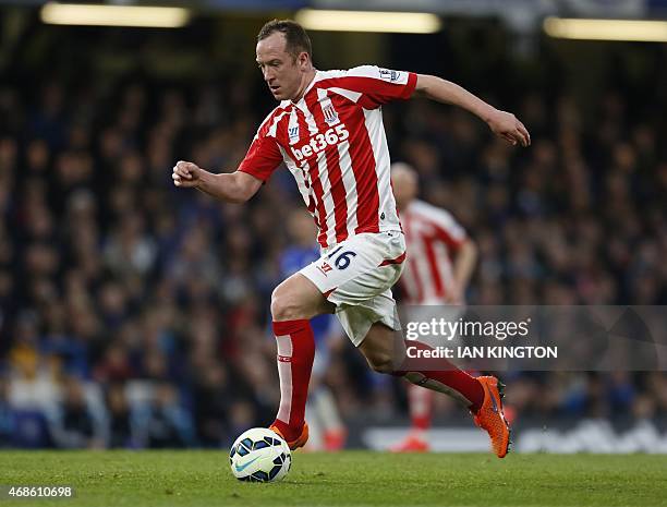 Stoke City's Scottish midfielder Charlie Adam runs with the ball during the English Premier League football match between Chelsea and Stoke City at...