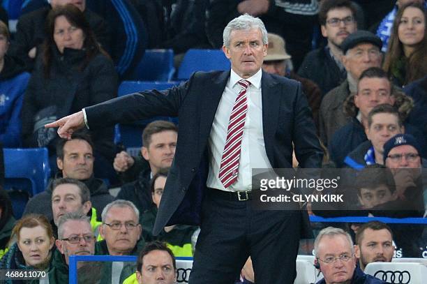 Stoke City's Welsh manager Mark Hughes gestures from the touchline during the English Premier League football match between Chelsea and Stoke City at...