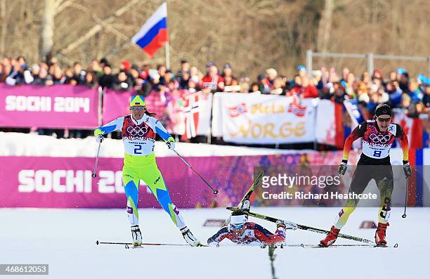 Katja Visnar of Slovenia and Denise Herrmann of Germany compete in the Finals of the Ladies' Sprint Free during day four of the Sochi 2014 Winter...