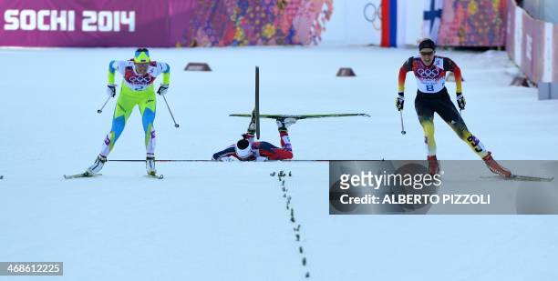 Norway's Marit Bjoergen falls as Slovenia's Katja Visnar and Germany's Denise Herrmann sprint during the Women's Cross-Country Skiing Individual...