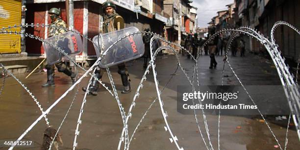 Paramilitary soldiers patrol on deserted street during Third consecutive day Curfew-like restrictions on February 11, 2014 in Srinagar, India. Strict...