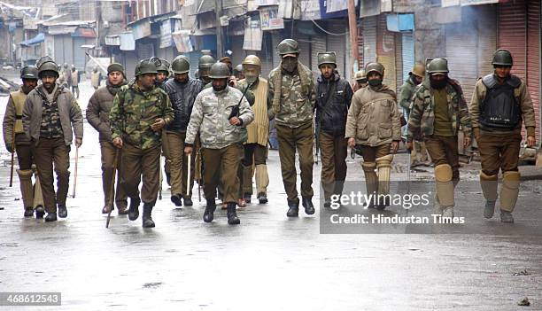 Policemen patrol on deserted street during Third consecutive day Curfew-like restrictions on February 11, 2014 in Srinagar, India. Strict...