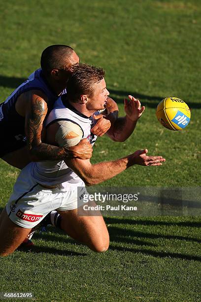Colin Sylvia of the Dockersgets his handball away while being tackled by Michael Walters during a Fremantle Dockers AFL Intra-Club match at Patersons...