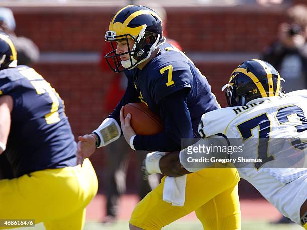 Shane Morris of the Michigan Wolverines tries to outrun Maurice Hurst during the Michigan Football Spring Game on April 4, 2015 at Michigan Stadium...