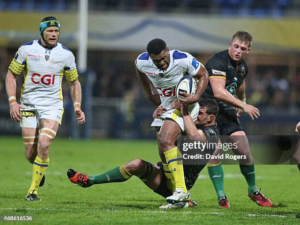 Naipolioni Nalaga of Clermont Auvergne is held by Calum Clark during the European Rugby Champions Cup quarter final match between Clermont Auvergne...