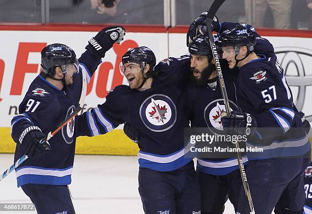 Jim Slater of the Winnipeg Jets celebrates his goal during first period action in an NHL game against the Vancouver Canucks at the MTS Centre on...