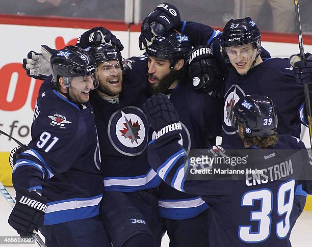 Jim Slater of the Winnipeg Jets celebrates his goal during first period action in an NHL game against the Vancouver Canucks at the MTS Centre on...