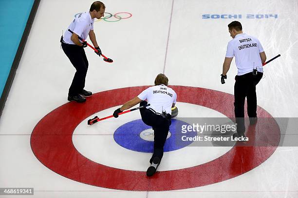 Teammates Sven Goldemann, John Jahr and Christopher Bartsch of Germany compete in the men's round robin session against Great Britain during day four...