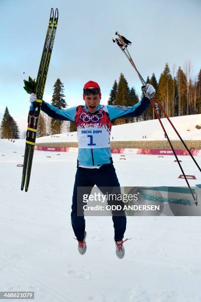 Norway's Ola Vigen Hattestad celebrates winnning gold on the podium during the Men's Cross-Country Skiing Individual Sprint Free Flower Ceremony at...