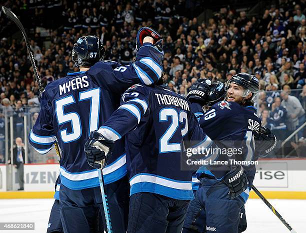 Tyler Myers, Chris Thorburn, Jim Slater and Jiri Tlusty of the Winnipeg Jets celebrate a first period goal against the Vancouver Canucks on April 4,...