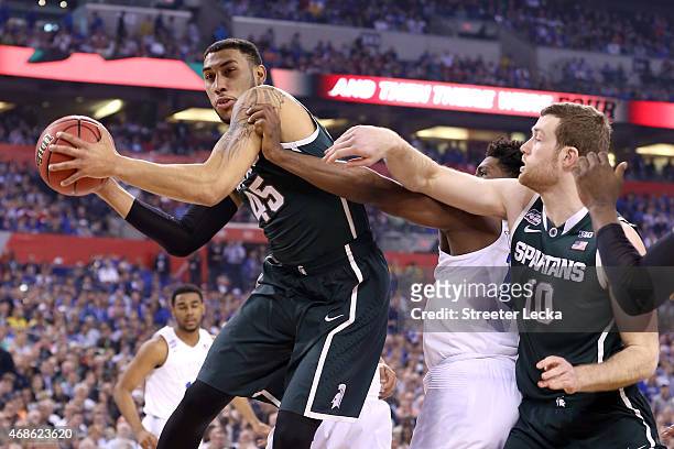 Denzel Valentine of the Michigan State Spartans handles the ball against Justise Winslow of the Duke Blue Devils in the first half during the NCAA...
