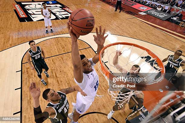 Jahlil Okafor of the Duke Blue Devils goes up for a dunk in the first half against Denzel Valentine of the Michigan State Spartans during the NCAA...