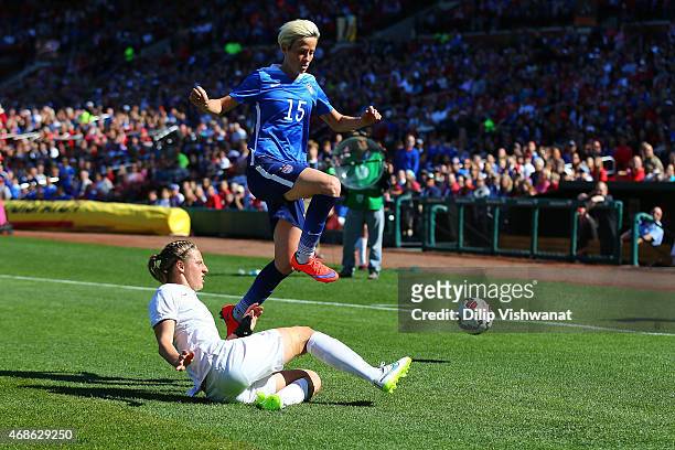 Rebekah Stott of New Zealand kicks the ball away from Megan Rapinoe of the United States at Busch Stadium on April 4, 2015 in St. Louis, Missouri.