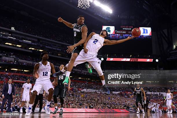 Quinn Cook of the Duke Blue Devils shoots against Marvin Clark Jr. #0 of the Michigan State Spartans in the second half during the NCAA Men's Final...