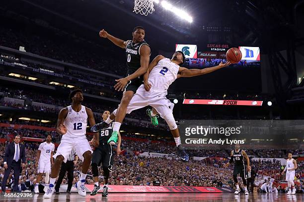 Quinn Cook of the Duke Blue Devils shoots against Marvin Clark Jr. #0 of the Michigan State Spartans in the second half during the NCAA Men's Final...
