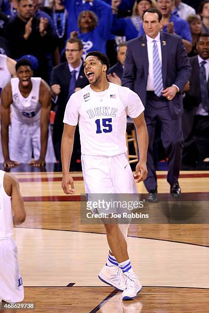 Jahlil Okafor of the Duke Blue Devils reacts after a play in the second half as Mike Krzyzewski looks on against the Michigan State Spartans during...