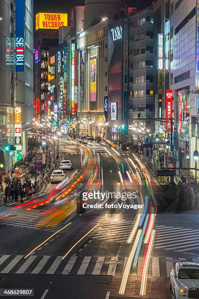 tokyo neon lights traffic and crowds at night shibuya japan - now voyager stock pictures, royalty-free photos & images