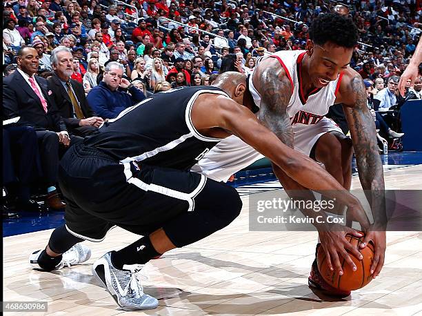 Jeff Teague of the Atlanta Hawks steals the ball from Jarrett Jack of the Brooklyn Nets at Philips Arena on April 4, 2015 in Atlanta, Georgia. NOTE...