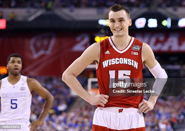 Sam Dekker of the Wisconsin Badgers reacts after a play in the first half as Andrew Harrison of the Kentucky Wildcats looks on during the NCAA Men's...