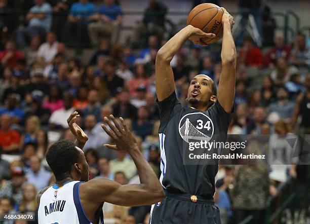 Shaun Livingston of the Golden State Warriors takes a shot against Al-Farouq Aminu of the Dallas Mavericks at American Airlines Center on April 4,...