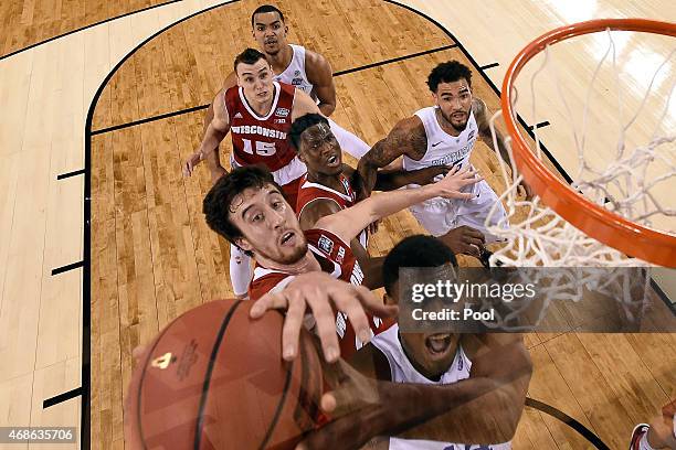 Frank Kaminsky of the Wisconsin Badgers tries to block Dakari Johnson of the Kentucky Wildcats in the first half during the NCAA Men's Final Four...