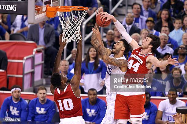 Willie Cauley-Stein of the Kentucky Wildcats goes up with the ball against Nigel Hayes and Frank Kaminsky of the Wisconsin Badgers in the second half...