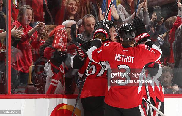 Mark Stone of the Ottawa Senators celebrates an overtime goal against the Washington Capitals with teammate Marc Methot at Canadian Tire Centre on...