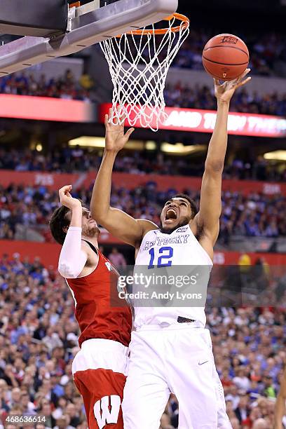 Karl-Anthony Towns of the Kentucky Wildcats drives to the basket against Frank Kaminsky of the Wisconsin Badgers in the second half during the NCAA...