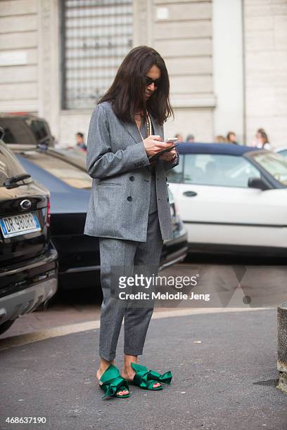 Stylist/Editor Viviana Volpicella exits Salvatore Ferragamo in wears a Dsquared2 suit and NumeroVentuno N21 shoes on Day 5 of Milan Fashion Week FW15...