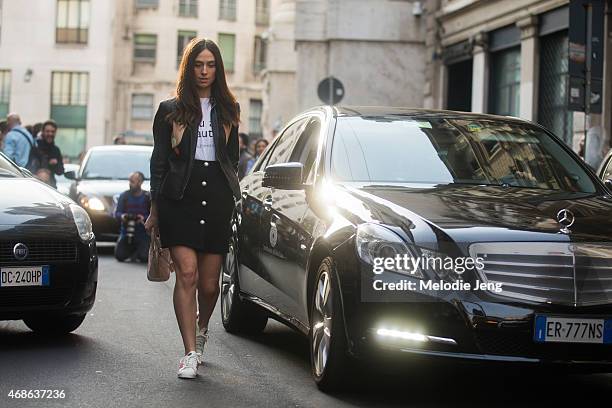 Blogger Erika Boldrin wears a Dondup leather jacket, Alberta Ferretti Philosophy t-shirt and skirt, and Adidas sneakers on Day 5 of Milan Fashion...