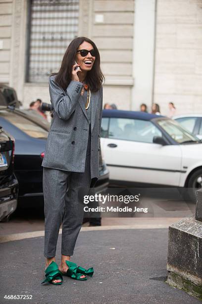 Stylist/Editor Viviana Volpicella exits Salvatore Ferragamo in wears a Dsquared2 suit and NumeroVentuno N21 shoes on Day 5 of Milan Fashion Week FW15...