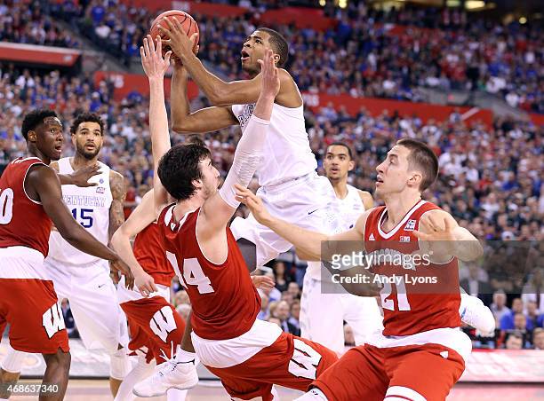 Aaron Harrison of the Kentucky Wildcats drives to the basket against Frank Kaminsky of the Wisconsin Badgers and is fouled in the second half during...