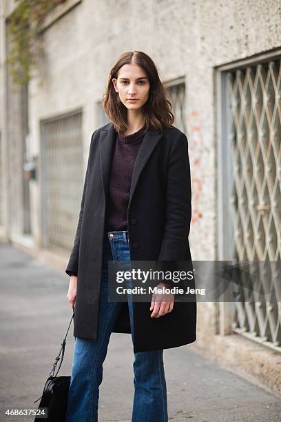 Model Ros Georgiou exits the Marco De Vincenzo show in a COS jacket, & Other stories sweater, J Brand Jeans, and a 3.1 Phillip Lim bag n Day 3 of...