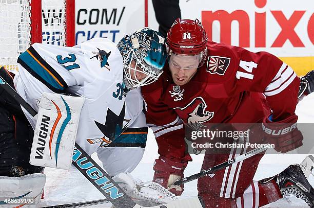 Goaltender Antti Niemi of the San Jose Sharks collides with Joe Vitale of the Arizona Coyotes during the first period of the NHL game at Gila River...