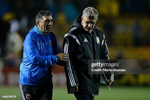 Coaches Ricardo 'Tuca' Ferretti of Tigres and Carlos Reinoso of Veracruz walk out the field at the end of a match between Tigres UANL and Veracruz as...