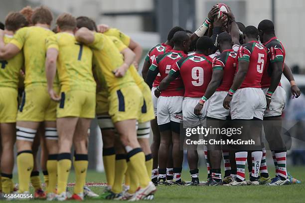 Kenya and Australia players go into team huddles before the start of the match between and Kenya and Australia during day two of the Tokyo Sevens...